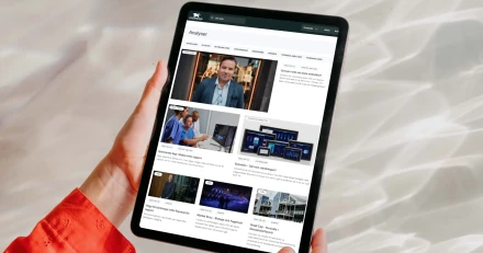 mockuuups ipad air mockup held by user against a bright silver background