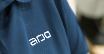 Arjo logo on blue shirt